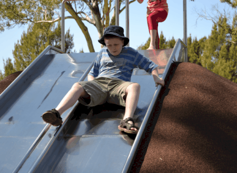 Kid going down slide